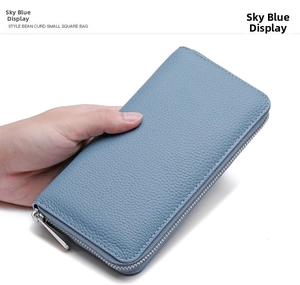 Close-up of sky blue leather wallet with litchi grain texture and silver metal zipper