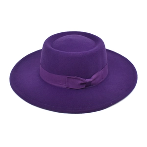 Detailed view of dark purple wool fedora hat with matching grosgrain ribbon and bow detail