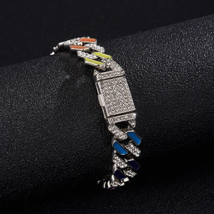 Hip hop silver Cuban link bracelet with colorful enamel and pavé rhinestones on display