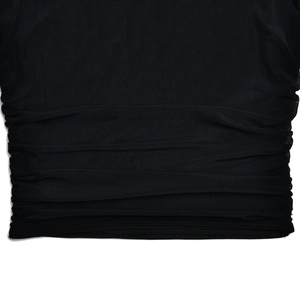 Detail of black mesh fabric showing horizontal ruched pleats on a bodycon skirt