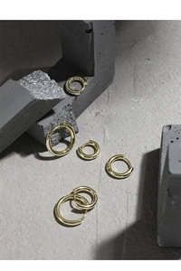 Detailed view of gold plated S925 sterling silver hoop earrings in three various sizes