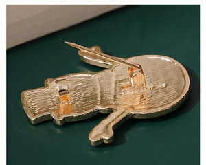 Close-up of the metal pin back and clasp mechanism on the cute snowman holiday brooch