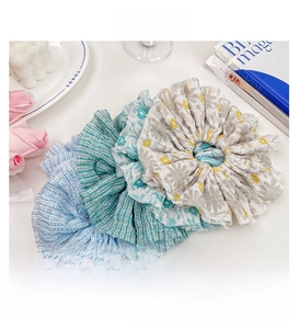 Detail of floral and striped oversized scrunchies with soft chiffon texture and folds
