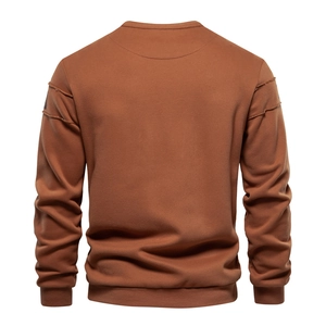 Close-up detail of quilted sleeve seams and brushed texture on brown crewneck sweatshirt