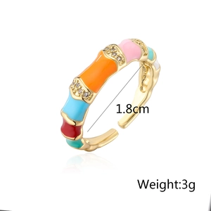 Detail of bamboo-shaped gold ring with colorful enamel inlay and zircon accents