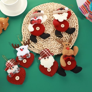 Christmas plush ornaments featuring Santa, reindeer, and snowman on a green background