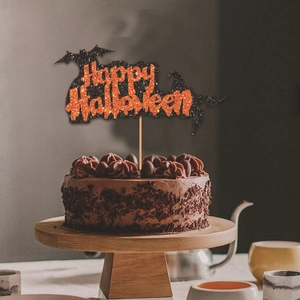 Glittery Happy Halloween cake topper with bat and ghost on a chocolate cake