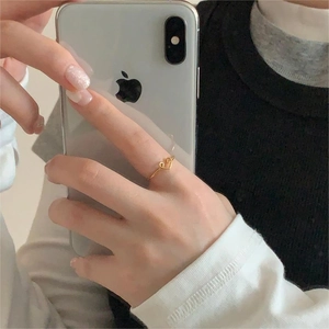 Minimalist gold open heart ring shown on finger with delicate hollow heart design