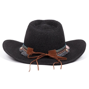 Close-up of black straw fedora featuring ethnic woven band with grey tassels and wood beads