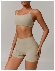 Close-up of seamless knitted texture on khaki green sports bra and yoga shorts set