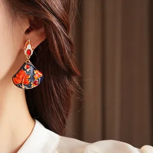 Vintage gold fan-shaped earrings with blue enamel, ginkgo leaves and red gemstones
