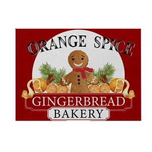 Detail of Christmas table mat featuring gingerbread man and orange spice motifs
