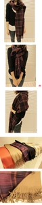 Detail view of multicolored plaid scarves with fringe ends in various stylish color options