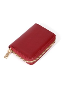 Detail of red pebbled leather accordion card holder with a gold metal zipper closure