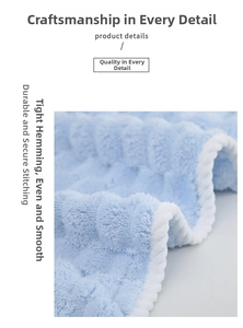 Close-up of light blue coral fleece towel with waffle texture and white stitched edging
