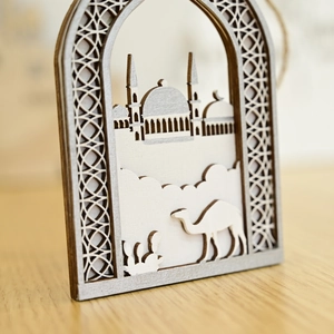 Detailed laser-cut wooden festive ornament featuring Islamic architecture and camels