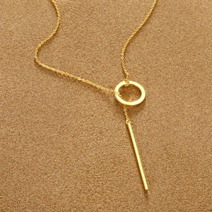 Detail view of gold geometric circle and bar pendant on a minimalist stainless steel chain