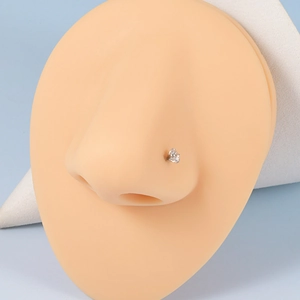 Professional G23 titanium nose stud with clear zircon stone shown on a silicone nose model