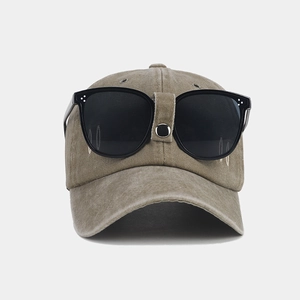 Detail of vintage baseball cap with integrated flip-up sunglasses on the front