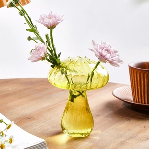 Close-up of a mushroom glass vase in lime green with textured water droplet details