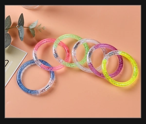Detail of six colorful LED bubble bracelets with glitter liquid and secure metal clasps