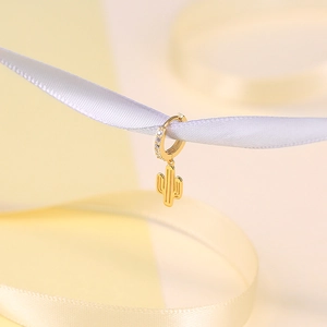 Macro shot of gold S925 sterling silver cactus drop earrings with pavé zircon