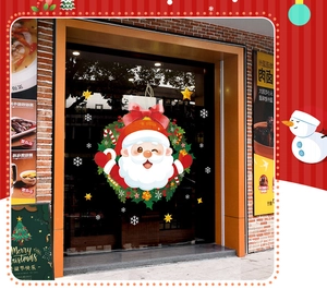 Detailed Christmas window decals featuring Santa Claus wreath and snowflakes on glass doors
