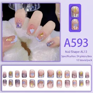Pink heart press-on nails with purple glitter and gold foil accents in 24 piece set
