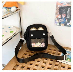 Detail of black canvas ita bag with clear PVC window for displaying badges and cute ears