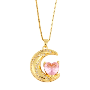 Macro detail of gold moon pendant featuring pink heart-shaped crystal on box chain