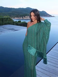 Elegant green one-shoulder knit maxi dress with fringe details and wave pattern