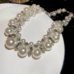 Elegant beaded necklace with lustrous white pearls and shimmering crystal clusters