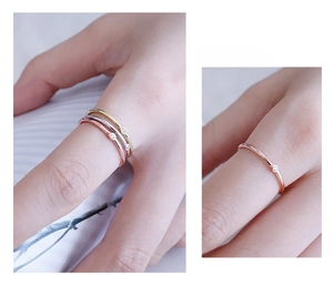 Macro detail of three minimalist S925 sterling silver thin rings with small zircons