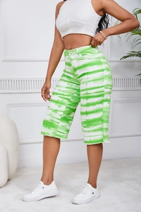 Detail of high-waisted green tie-dye knee-length denim shorts for women in casual style
