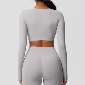 Vue de dos de l'ensemble haut de sport gris clair et pantalon de yoga taille haute