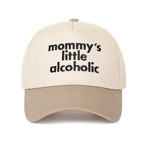 Detail of 3D embroidery text on two-tone off-white and khaki baseball cap