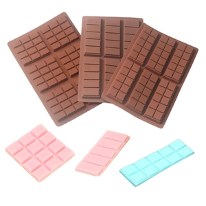 Three brown silicone chocolate molds for making patterned bars on a white background