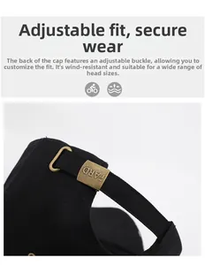 Detail of black cotton baseball cap with adjustable copper buckle and engraved metal tab