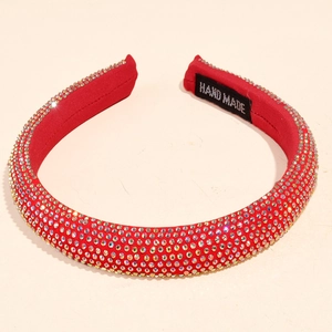 Detail of red rhinestone headband featuring a Hand Made label and shimmering crystals