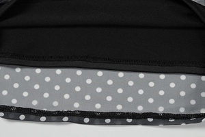 Detailed close-up of double-layer mesh hem with white polka dots and fine stitching
