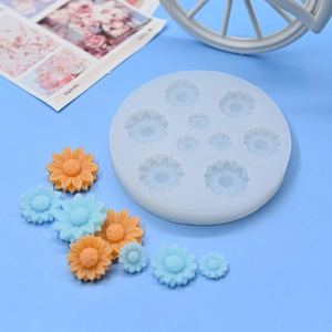 Macro detail of daisy flower silicone mold showing nine varied cavities for DIY resin craft