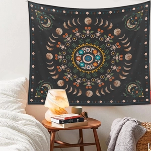 Bohemian moon phase tapestry with mandala floral design displayed in a cozy bedroom
