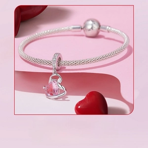 Detailed macro view of pink heart zircon pendant on 925 silver snake chain necklace