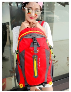 Large capacity red hiking backpack with yellow zipper details shown on an Asian model