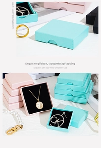 Close-up of square jewelry gift boxes in pink and blue with black sponge lining