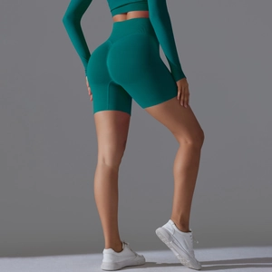 Detail view of seamless dark teal yoga shorts featuring high waist and scrunch butt design