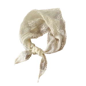 Beige lace triangle scarf with floral embroidery and crochet edge on white background