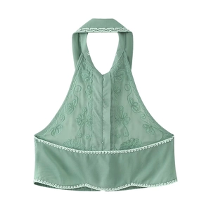 Détail du haut dos nu vert avec broderie florale complexe et finitions en dentelle blanche