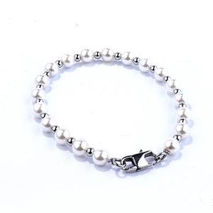 Elegant minimalist white pearl bracelet with stainless steel lobster clasp on white background