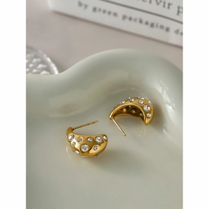 Detailed macro view of 18k gold-plated C-shaped hoop earrings with inlaid clear zircons